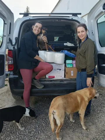 Female volunteers loading a van with donations to distribute