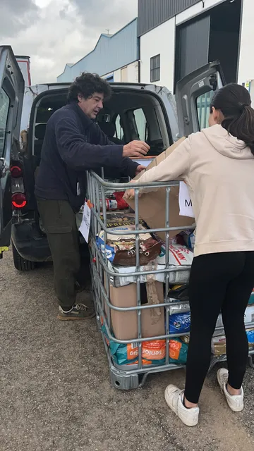Loading a van with a pallet cage of donations for another shelter