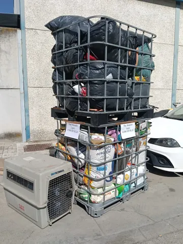 A pallet cage full of sacks and donated food ready to distribute